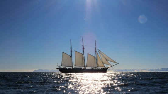 Sonnen scheint auf das Segelschiff mit offenen Segeln