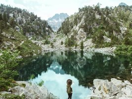 Wanderer an einem Bergsee in den spanischen Pyrenäen