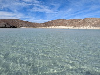 Glasklares flaches Wasser eines sehr breiten Strandes